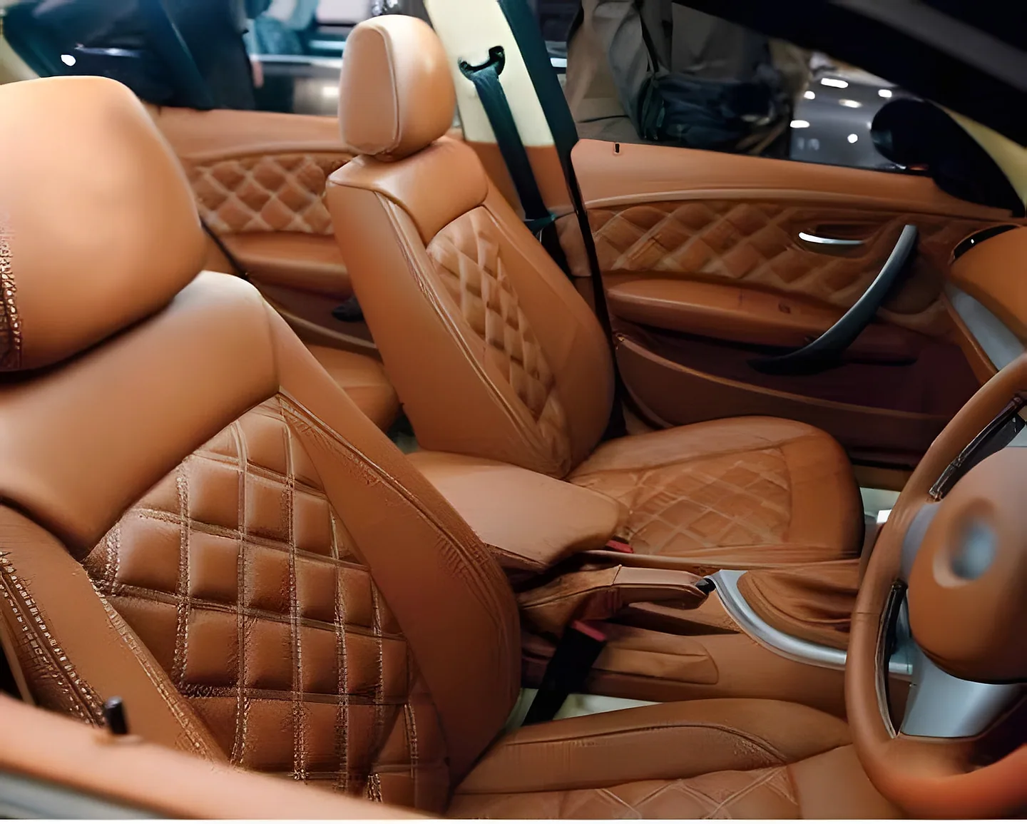 Tan diamond-quilted seat covers fitted to the front seats of a car