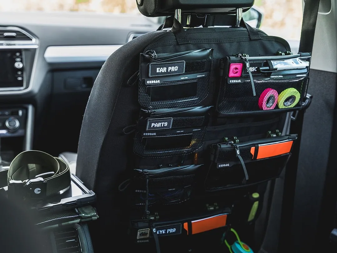 A seat-back organiser with pockets fitted behind a front seat