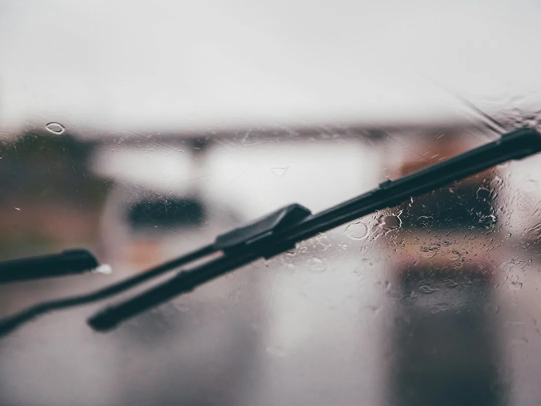 A black wiper blade resting on a windscreen